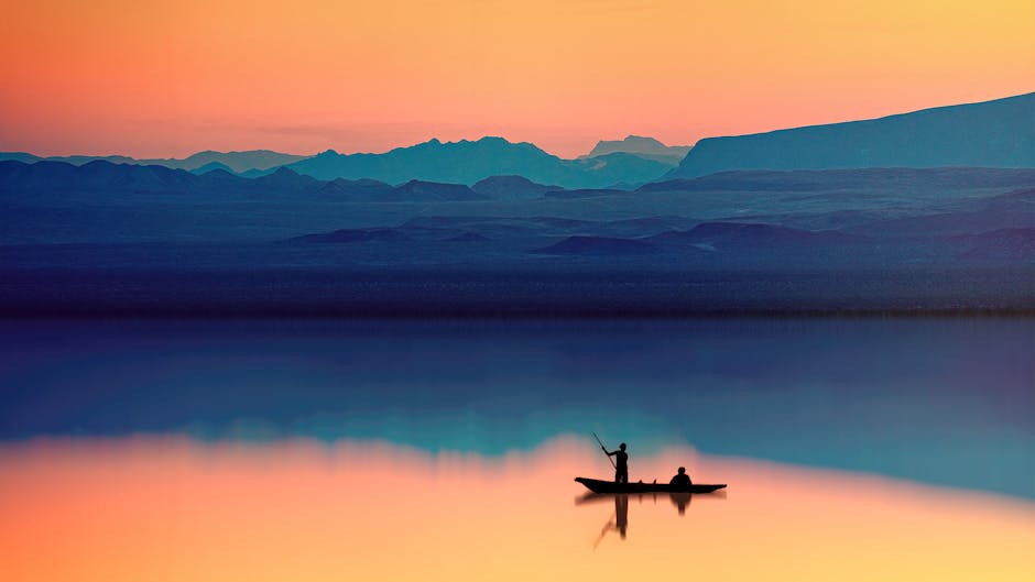 Silhouettes of people in a boat at sunset representing peaceful therapy